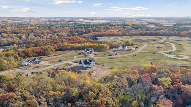 birds eye view of property featuring a wooded view