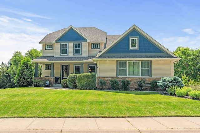 craftsman house with a porch and a front lawn