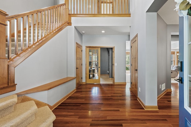 foyer entrance with dark hardwood / wood-style flooring and french doors