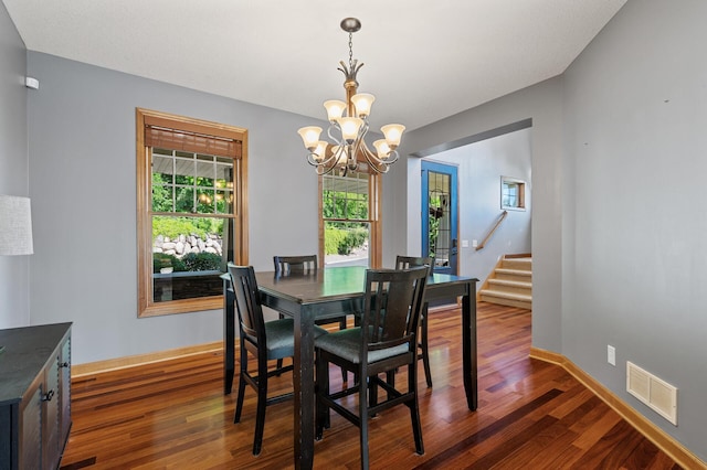 dining room featuring a chandelier and dark hardwood / wood-style flooring