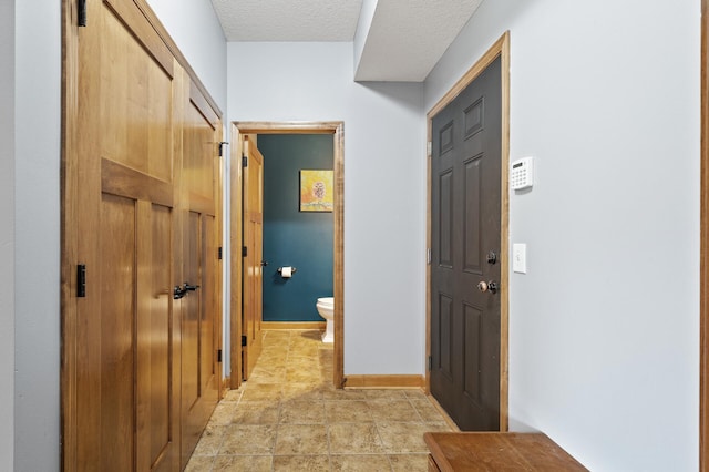 hall with a textured ceiling