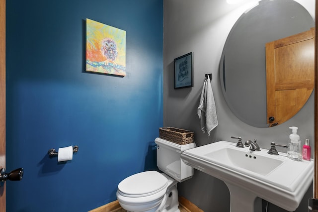 bathroom featuring toilet and sink