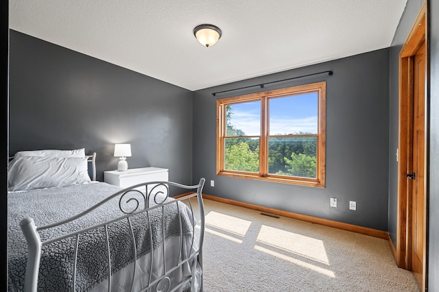 carpeted bedroom featuring a textured ceiling