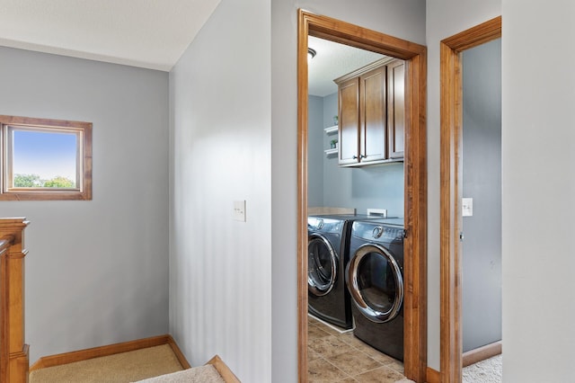 laundry area featuring cabinets, independent washer and dryer, and light tile patterned floors