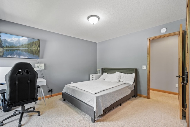 carpeted bedroom with a textured ceiling