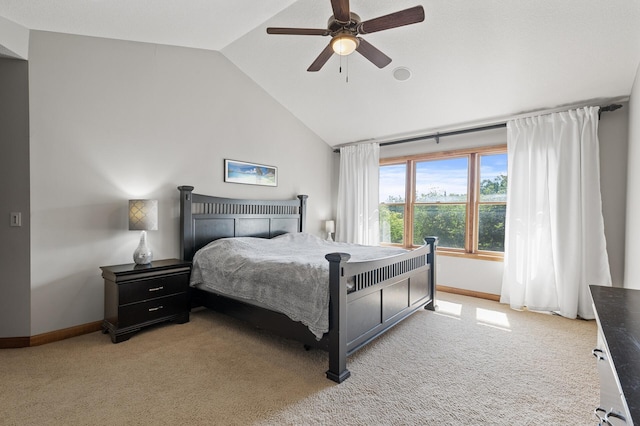 carpeted bedroom with ceiling fan and high vaulted ceiling