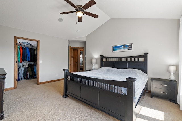 bedroom featuring vaulted ceiling, ceiling fan, a spacious closet, light colored carpet, and a closet