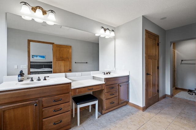 bathroom with vanity, a textured ceiling, and tile patterned floors