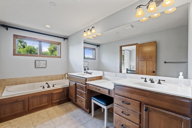 bathroom featuring vanity, plenty of natural light, a bathtub, and tile patterned flooring