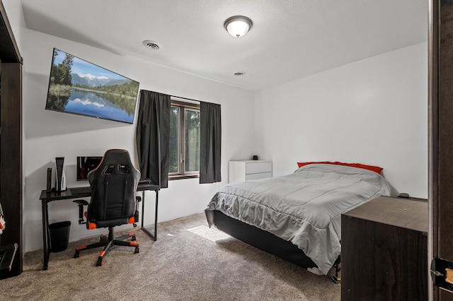 carpeted bedroom featuring a textured ceiling