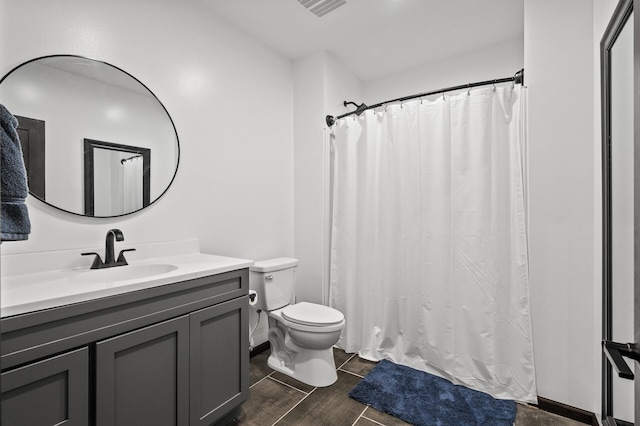 bathroom featuring hardwood / wood-style floors, vanity, and toilet