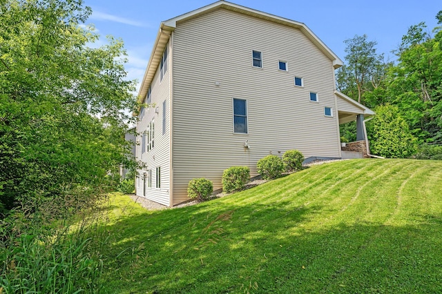 view of side of home featuring a yard