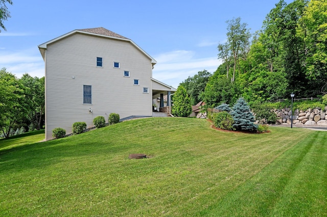 view of side of property with a yard