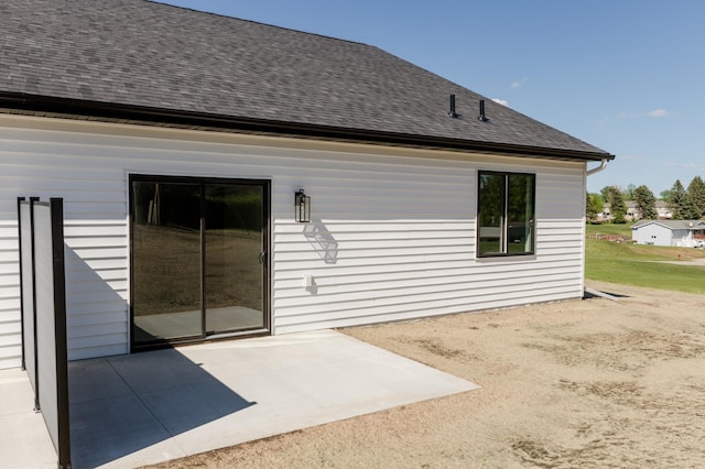 102 3rd Ave, Pelican Rapids, MN 56572 - rear view of house with a patio area and a shingled roof