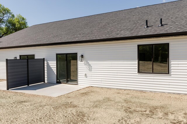 102 3rd Ave, Pelican Rapids, MN 56572 - back of house featuring a patio and a shingled roof