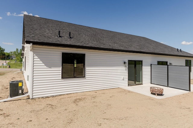 102 3rd Ave, Pelican Rapids, MN 56572 - rear view of property with a patio area, roof with shingles, and an outdoor fire pit