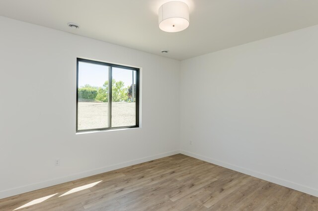 102 3rd Ave, Pelican Rapids, MN 56572 - spare room with light wood-type flooring and a smoke detector