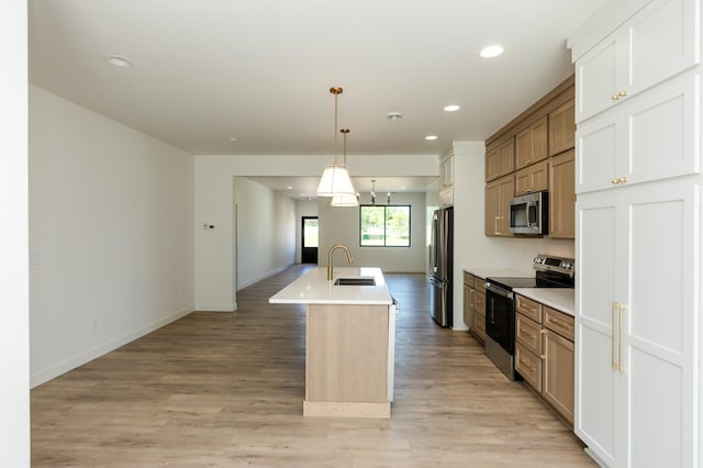102 3rd Ave, Pelican Rapids, MN 56572 - kitchen featuring appliances with stainless steel finishes, a center island with sink, decorative light fixtures, recessed lighting, and light countertops