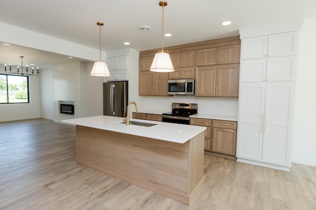 102 3rd Ave, Pelican Rapids, MN 56572 - kitchen with appliances with stainless steel finishes, light wood-style floors, recessed lighting, light countertops, and pendant lighting