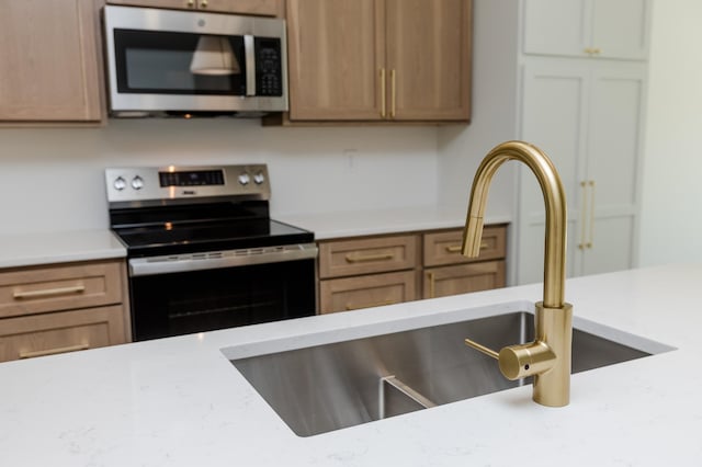 102 3rd Ave, Pelican Rapids, MN 56572 - kitchen with appliances with stainless steel finishes and light stone counters