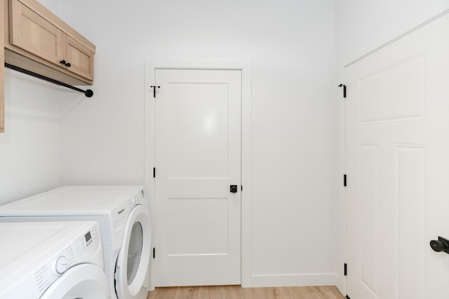 102 3rd Ave, Pelican Rapids, MN 56572 - washroom with washing machine and dryer, cabinet space, and light wood-type flooring