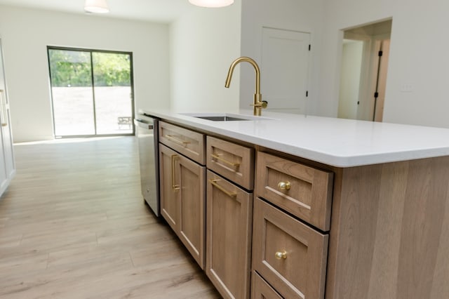 102 3rd Ave, Pelican Rapids, MN 56572 - kitchen with dishwasher, light wood-type flooring, light countertops, and a center island with sink