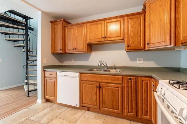 kitchen with light wood-type flooring, white appliances, and sink