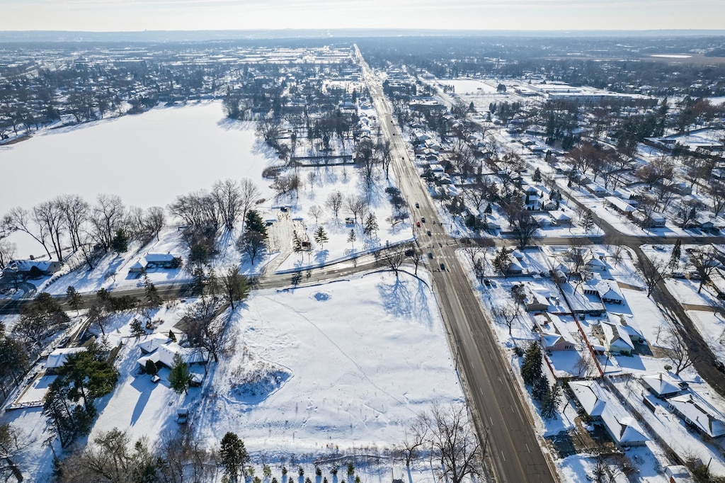 snowy aerial view with a residential view