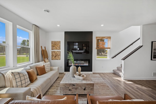 living room with a fireplace and light hardwood / wood-style flooring