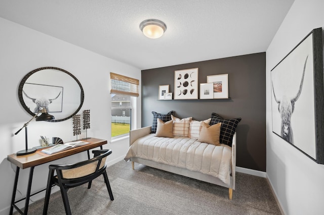 carpeted bedroom featuring a textured ceiling