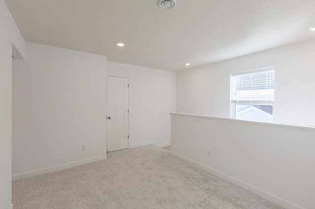 spare room with light colored carpet