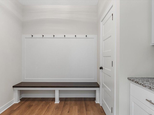 mudroom featuring baseboards and wood finished floors