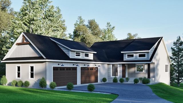 modern farmhouse featuring a garage, asphalt driveway, and a front yard