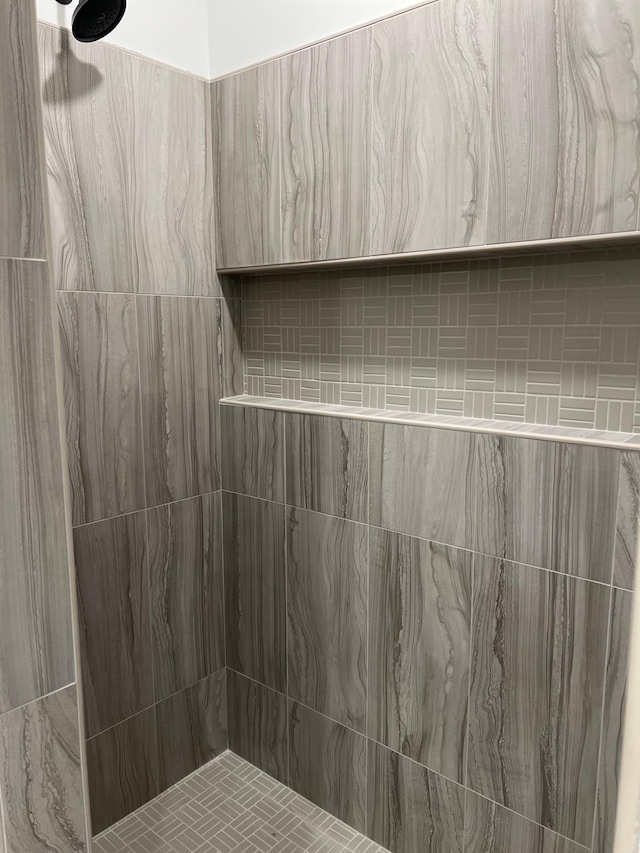 full bathroom with tiled shower