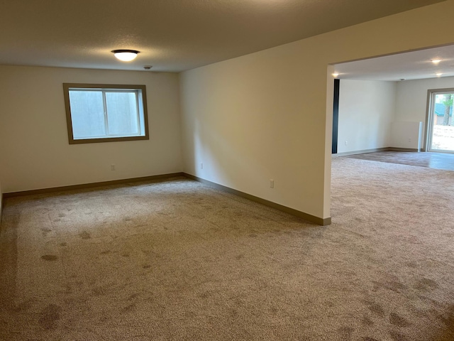 carpeted spare room with baseboards