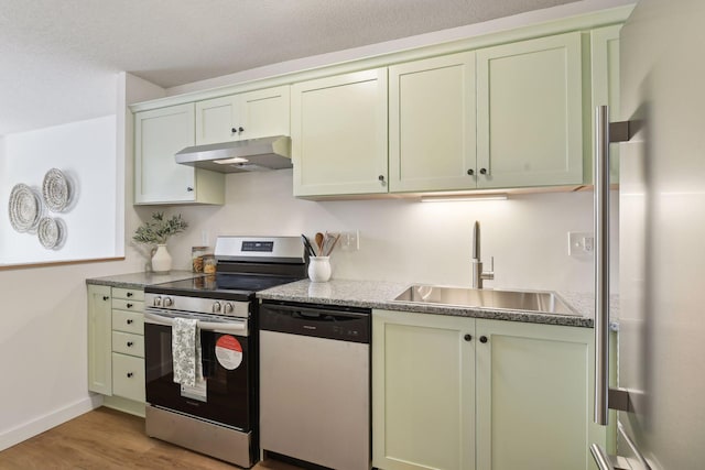 kitchen with sink, light hardwood / wood-style flooring, and appliances with stainless steel finishes