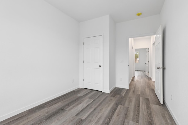 unfurnished bedroom with dark hardwood / wood-style floors