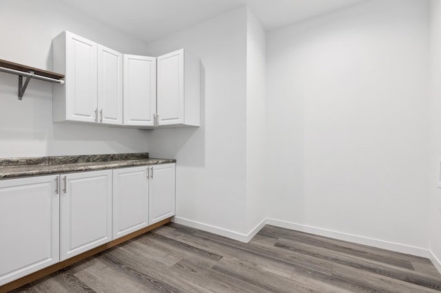 laundry area with hardwood / wood-style flooring