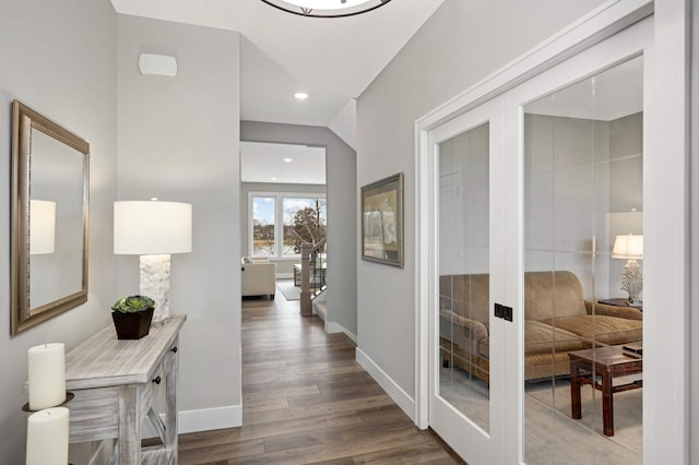 corridor with dark hardwood / wood-style flooring and french doors