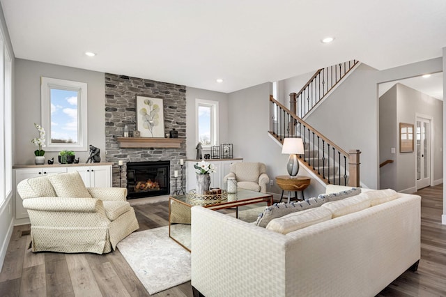 living room with a fireplace, hardwood / wood-style flooring, and a wealth of natural light