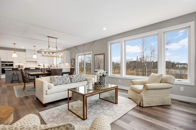 living room featuring hardwood / wood-style flooring and a notable chandelier