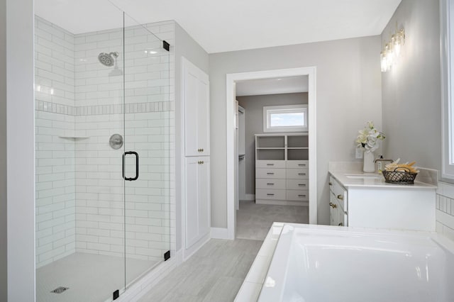 bathroom with vanity and separate shower and tub