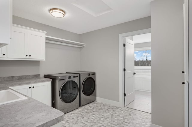 laundry room with washer and clothes dryer, cabinets, and sink