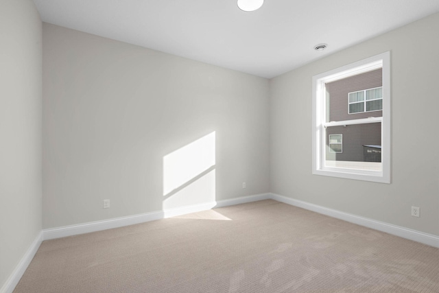 unfurnished room featuring light carpet