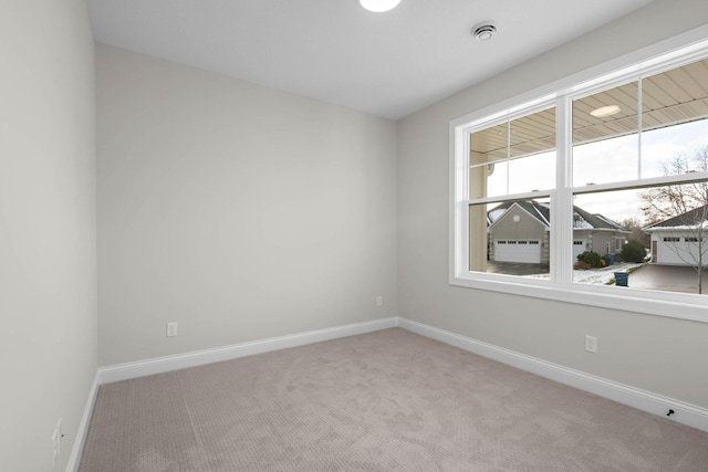 unfurnished room featuring light colored carpet