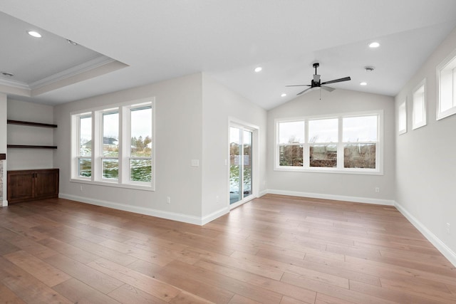 unfurnished living room with light wood-type flooring, a wealth of natural light, and crown molding