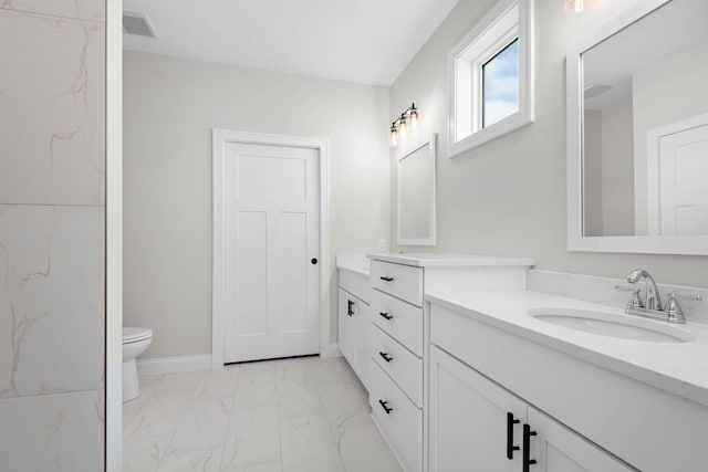 bathroom featuring vanity and toilet