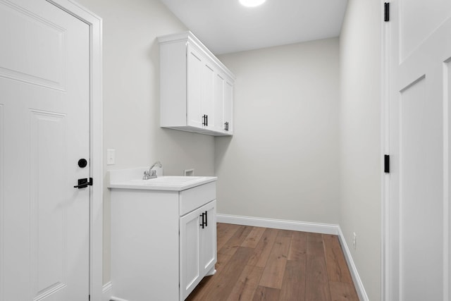 washroom featuring cabinets, washer hookup, light hardwood / wood-style floors, and sink