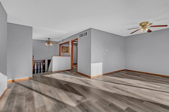 unfurnished living room with ceiling fan and hardwood / wood-style floors