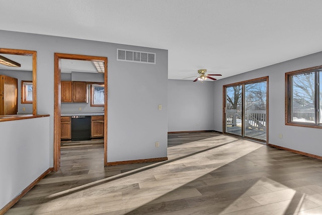 unfurnished living room with ceiling fan and hardwood / wood-style floors